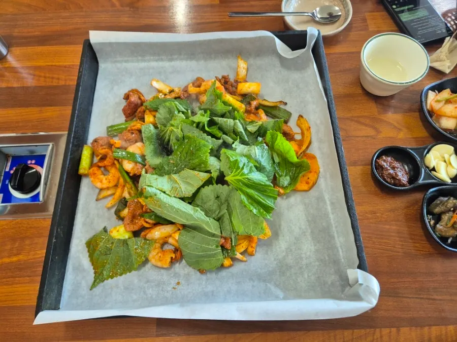 Two servings of shrimp duck jumulleok on the griddle