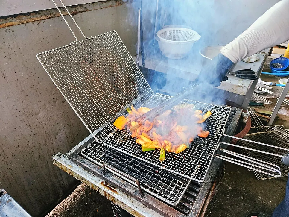Charcoal-par-grilled duck being cooked