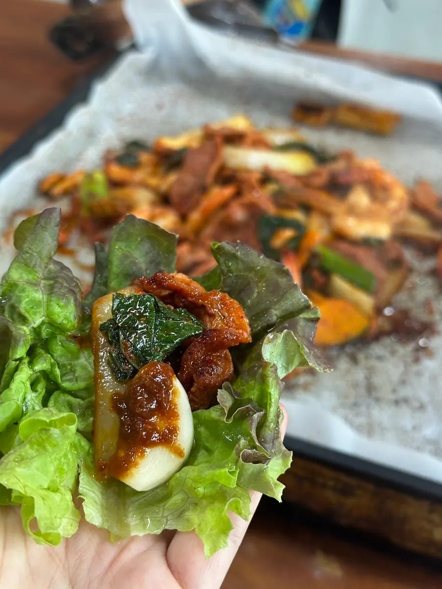 Duck jumulleok placed in a lettuce wrap