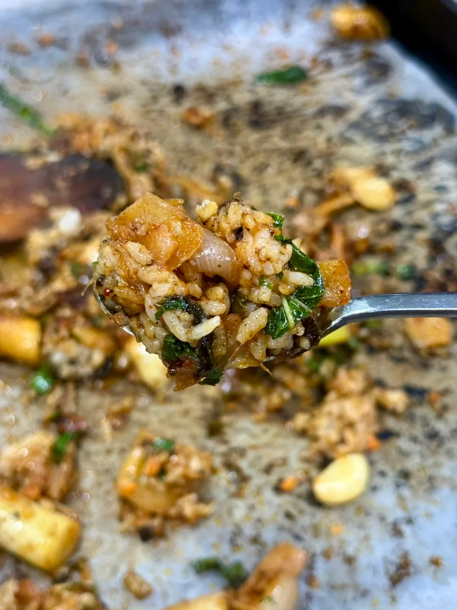 A spoonful of fried rice mixed with jumulleok sauce