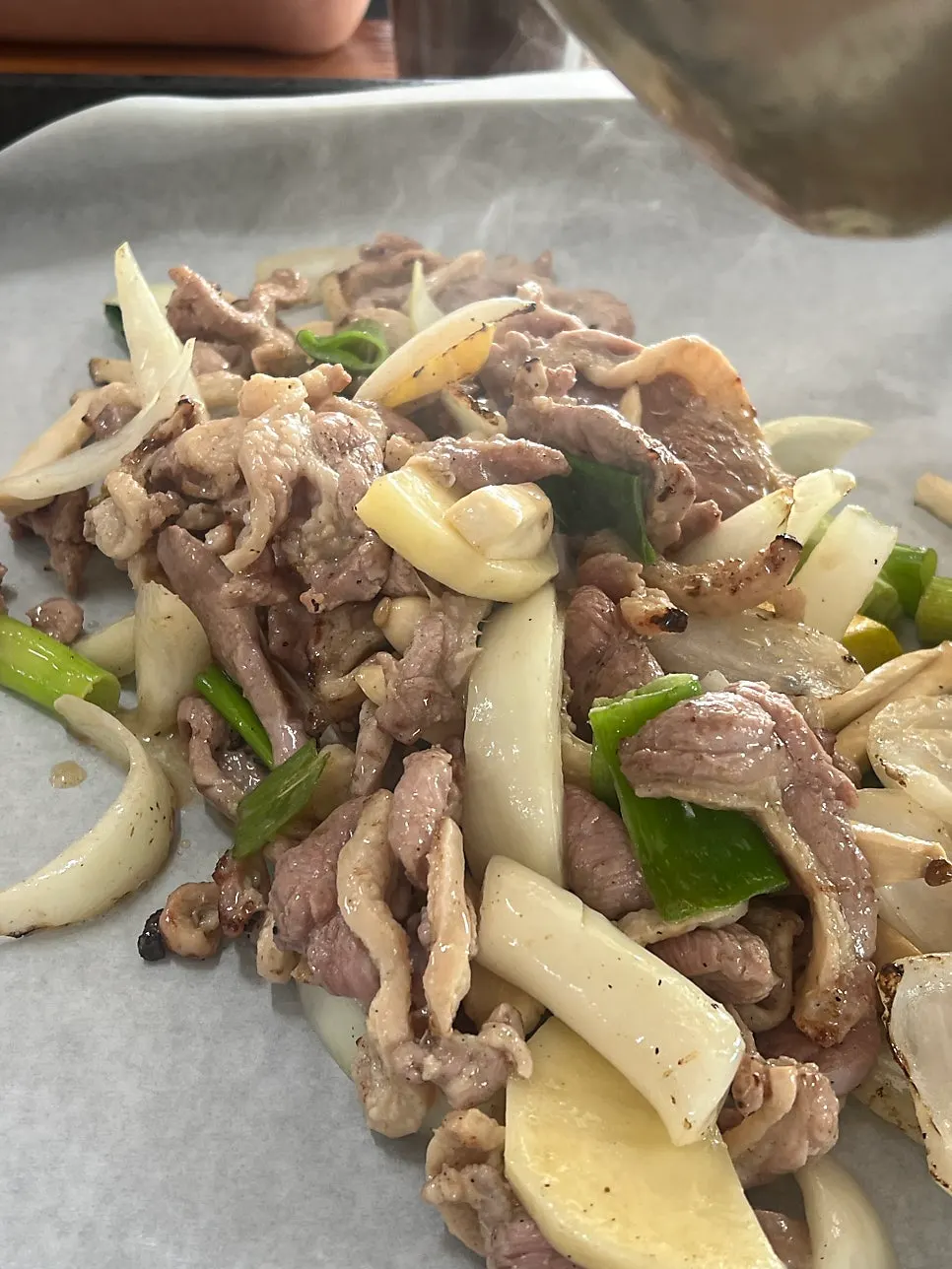 Pre-grilled duck meat placed on the grill