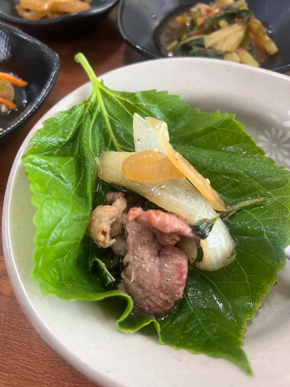 Duck meat placed on a perilla leaf wrap
