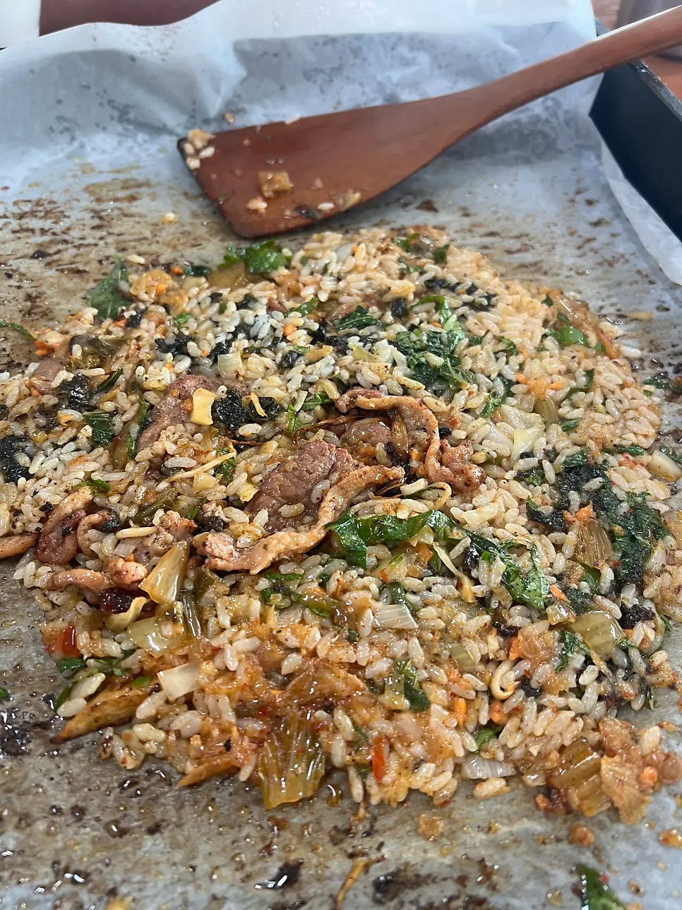 Duck fried rice being stir-fried on the grill