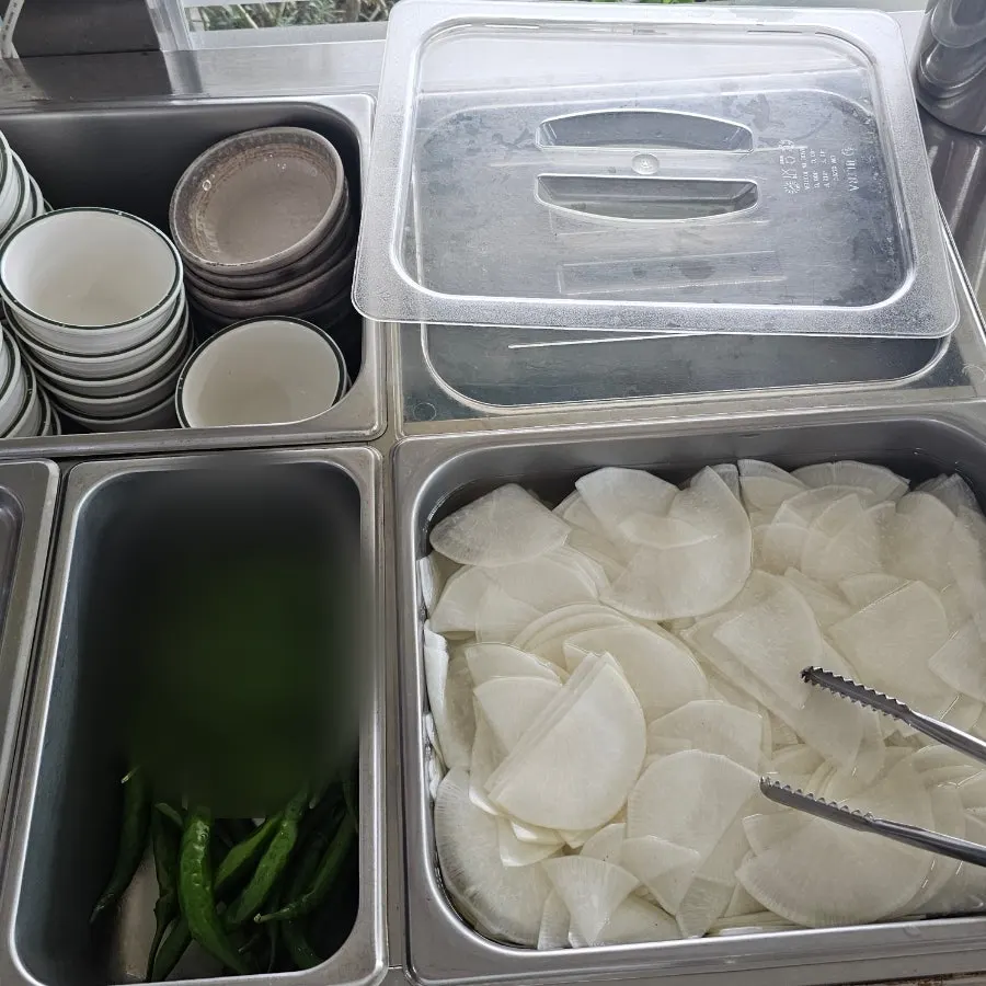 A bite of duck with vegetables and side dishes