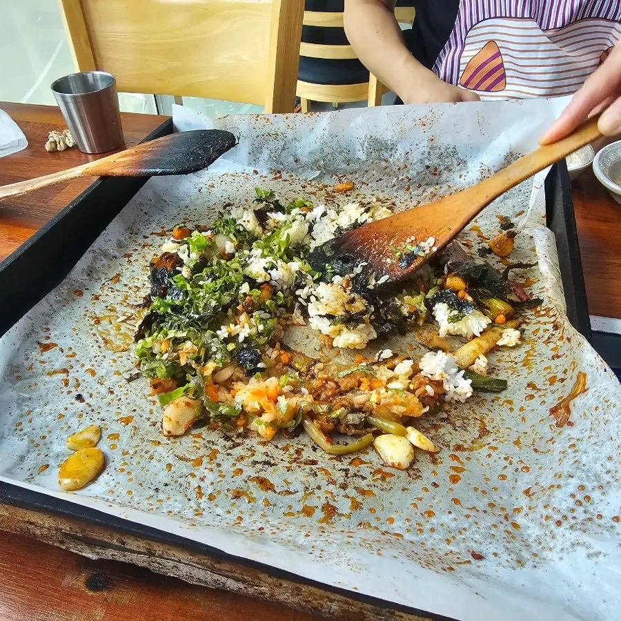 Fried rice cooked in the leftover sauce, pressed down while eating