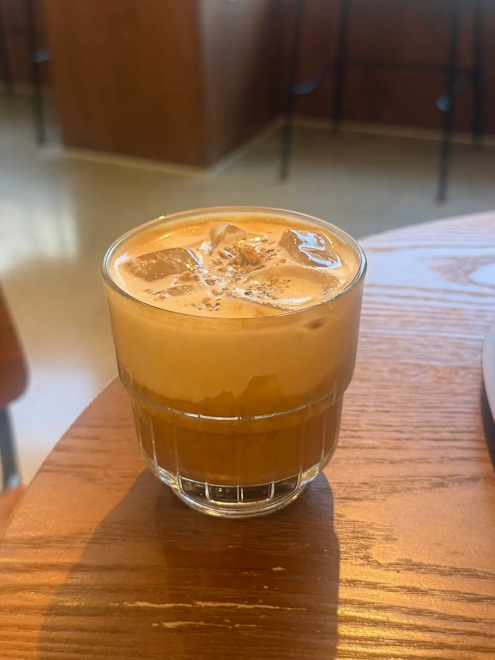 Close-up of the Dripper Latte topped with crushed almonds