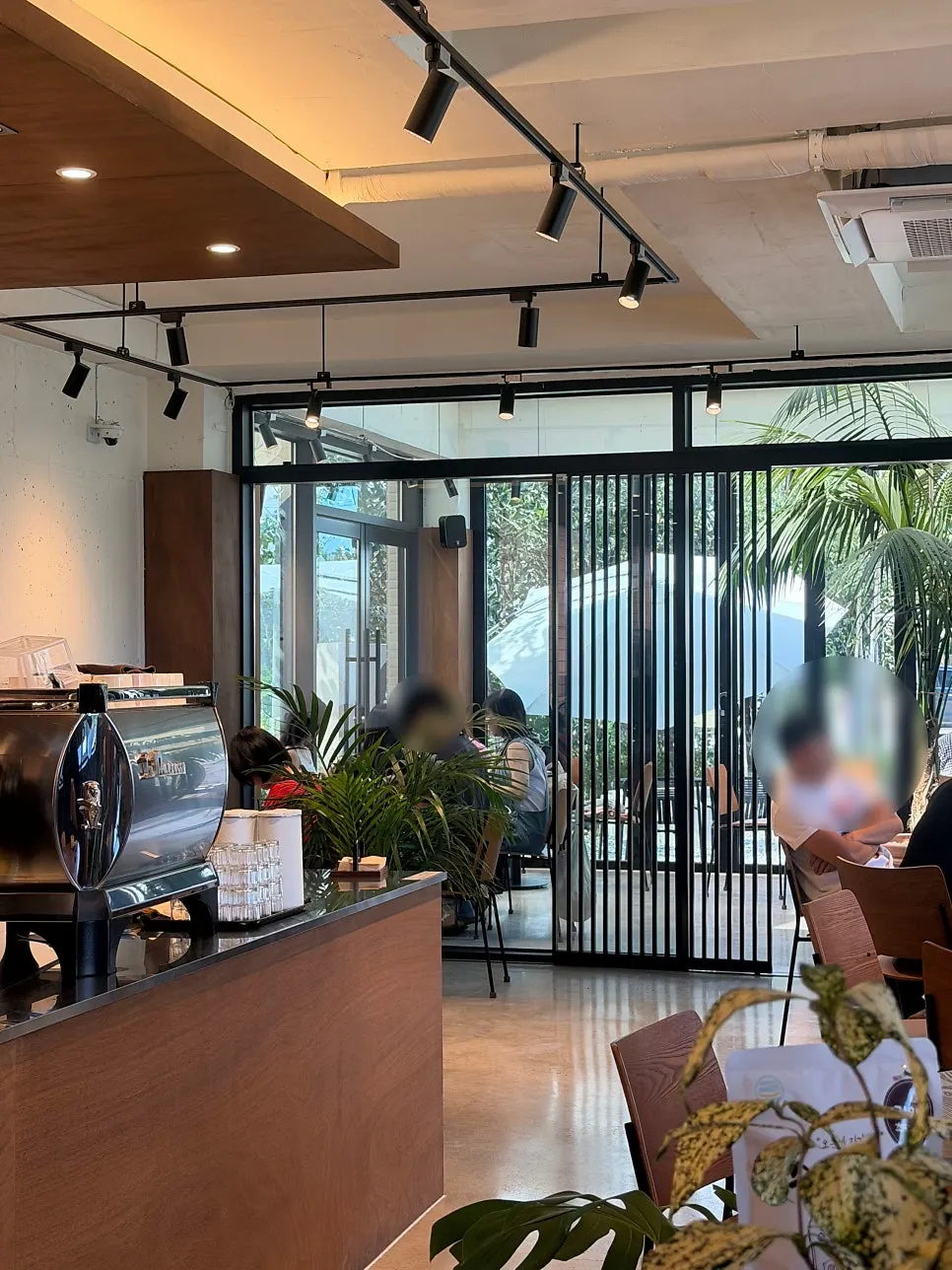 Café seating by the floor-to-ceiling windows