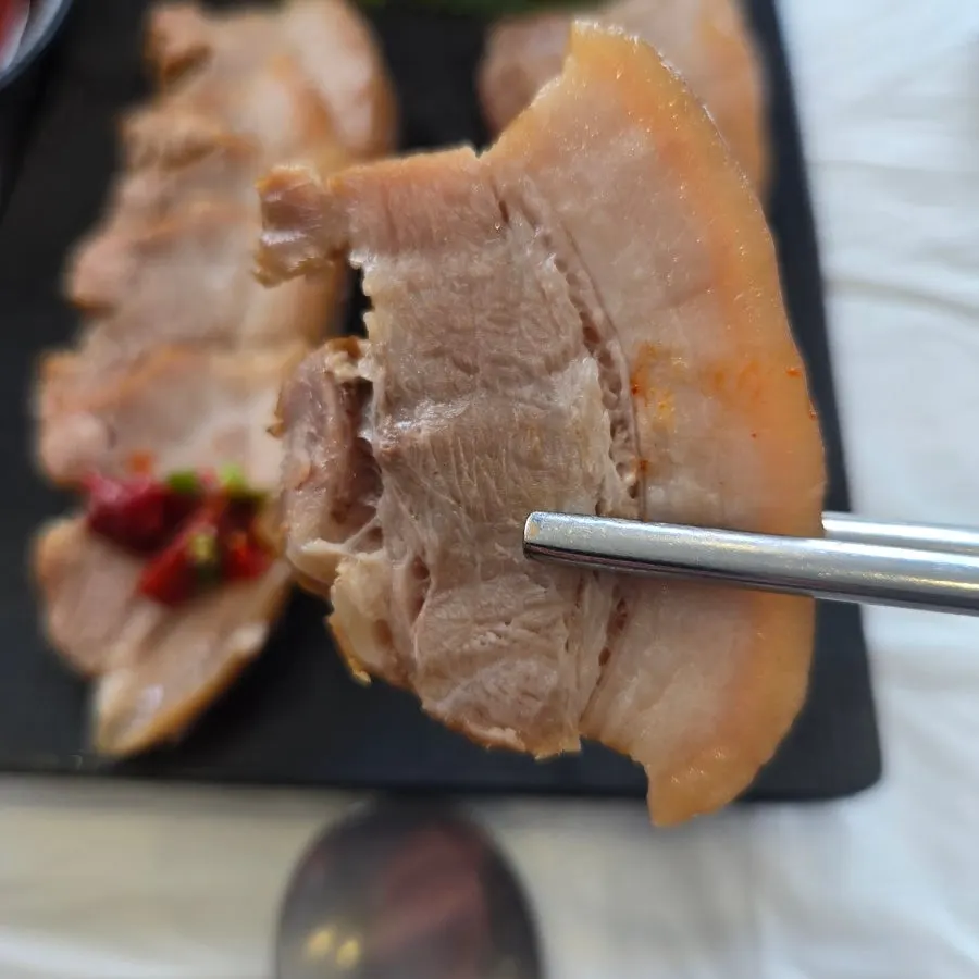 Picking up a piece of boiled pork