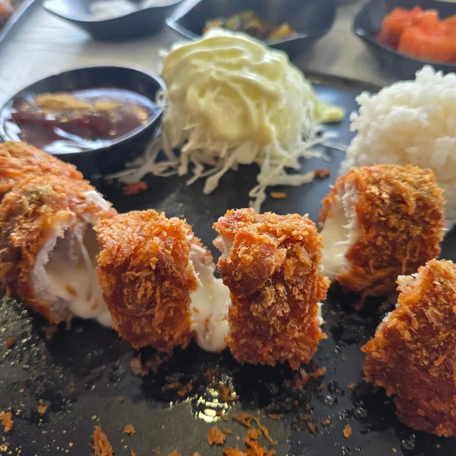 Cross-section of cheese roll cutlet with stretching cheese