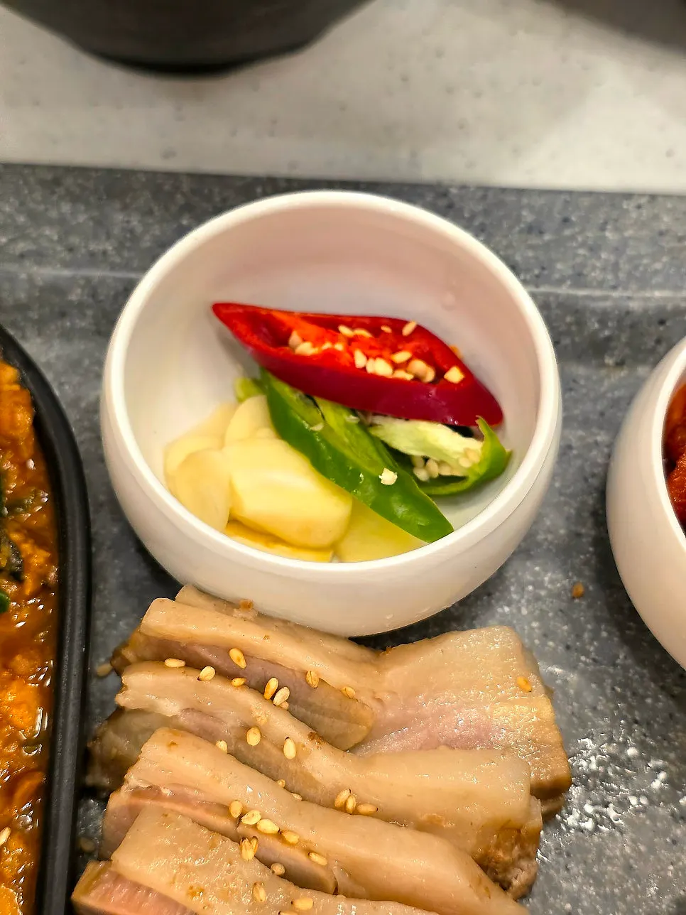 A piece of gabrisal boiled pork held with chopsticks
