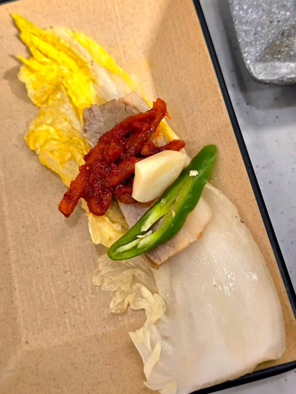 A piece of boiled pork eaten with the side dish