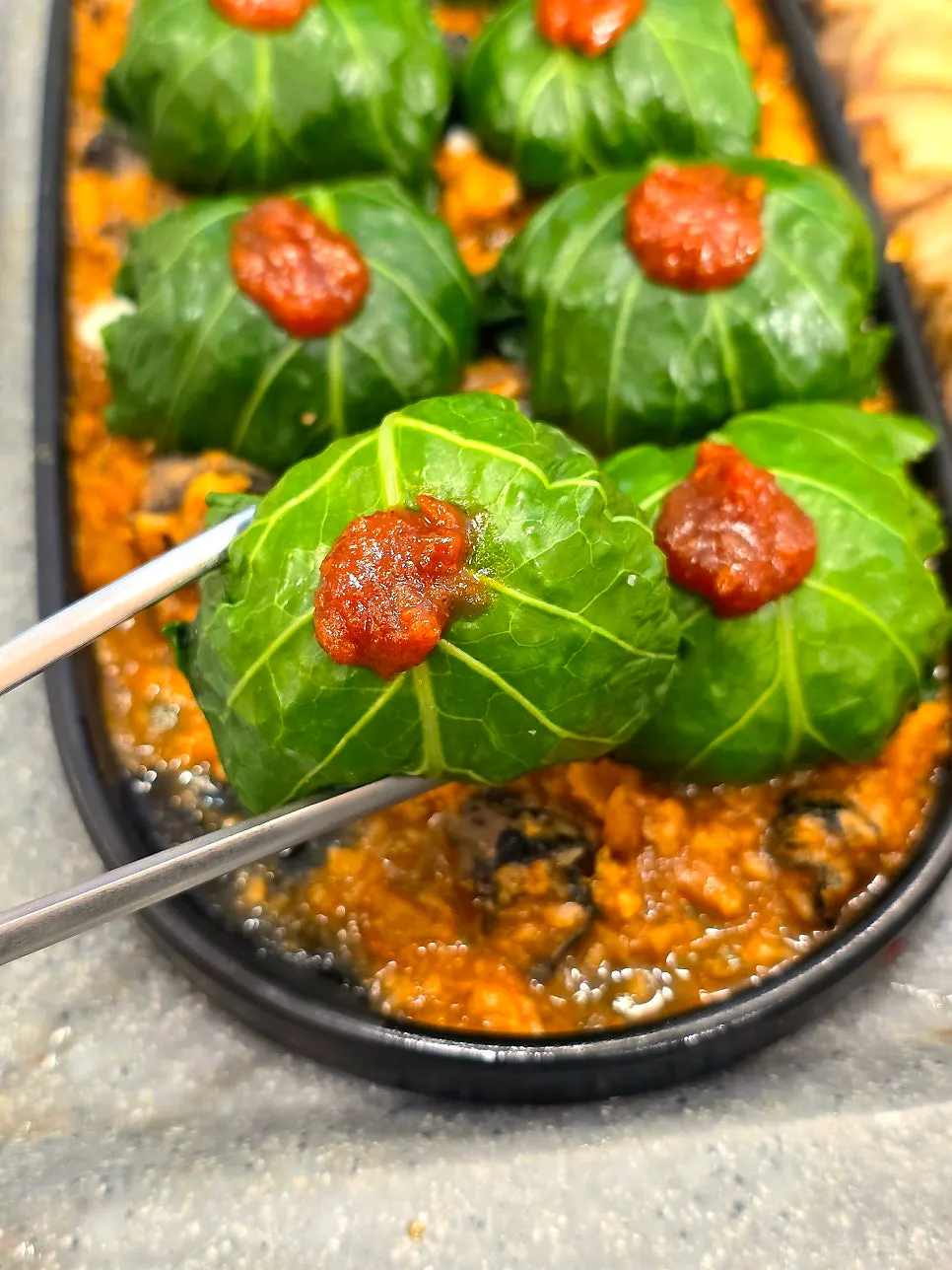 Sauce on top of the rolled-up lettuce wrap