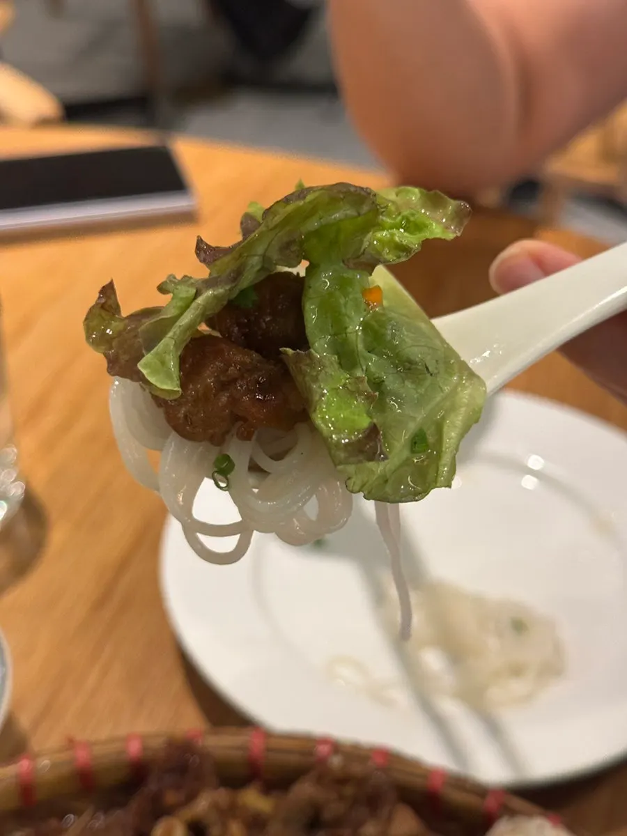 A bite of thin pho noodles