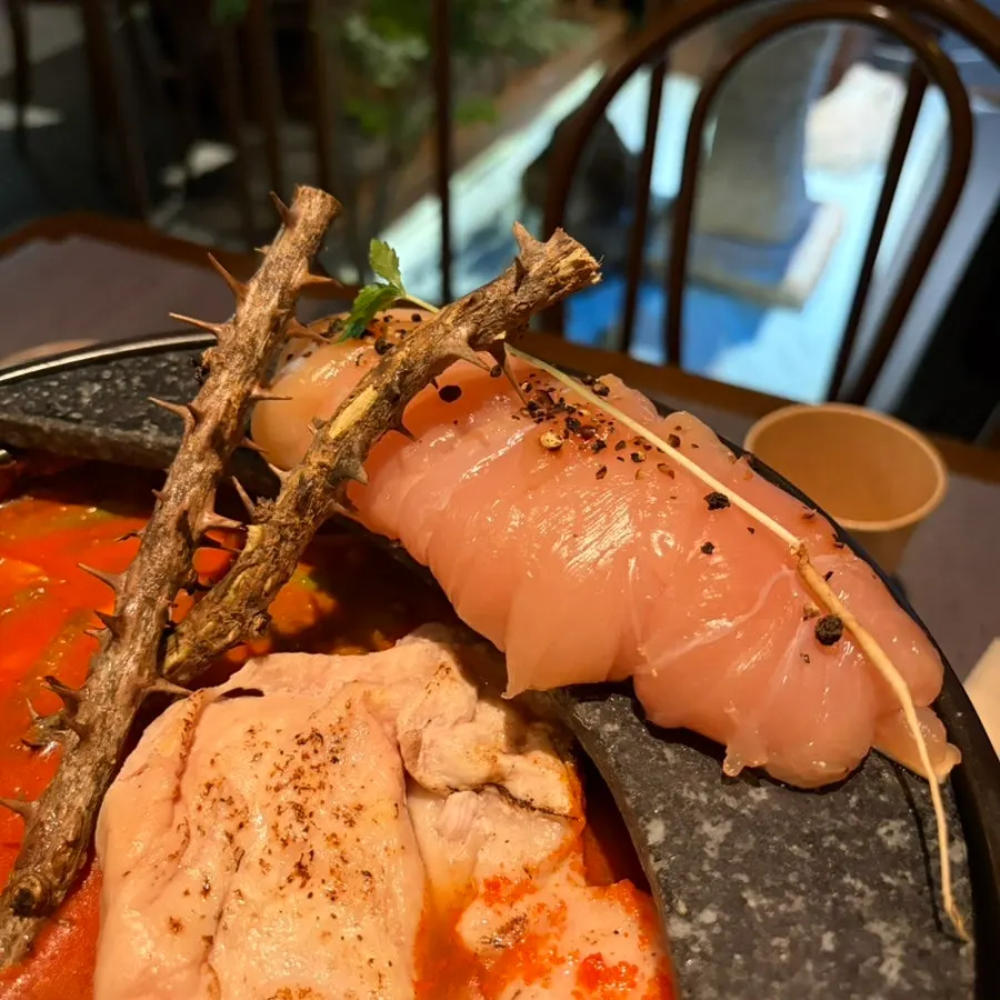 A bowl generously filled with chicken from the hot pot