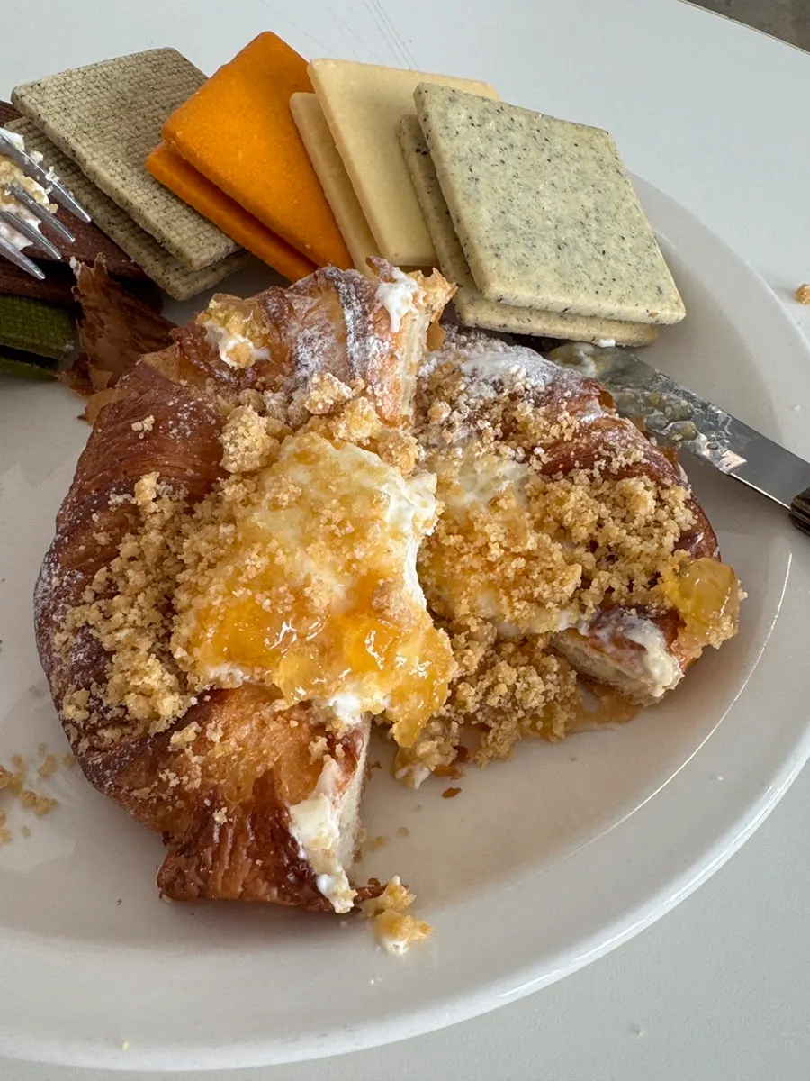 Cross-section of apple crumble pie filled with cream