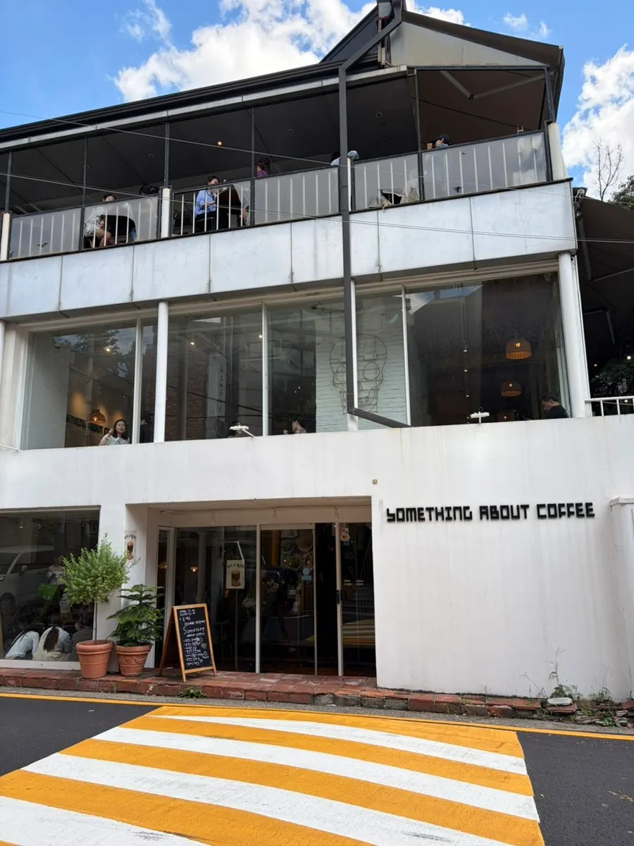 Interior of Something About Coffee packed with customers