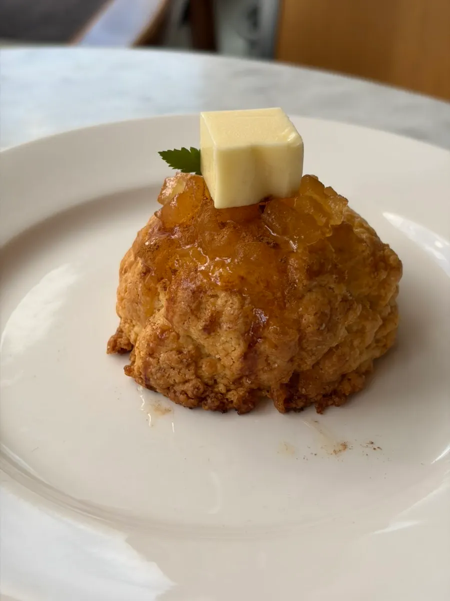 Apple cinnamon butter scone topped with butter