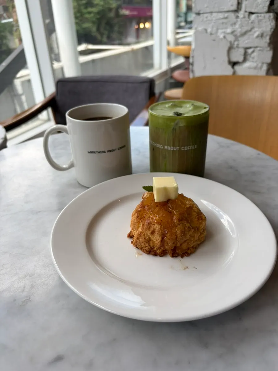 Scone with apple compote served alongside coffee