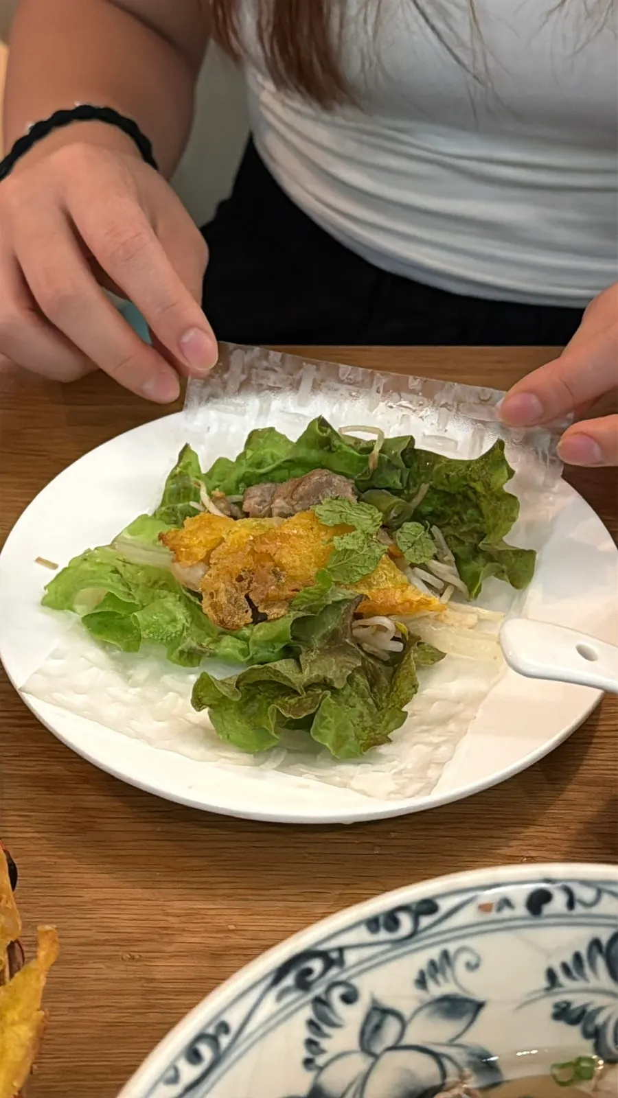 Wrapping banh xeo in rice paper
