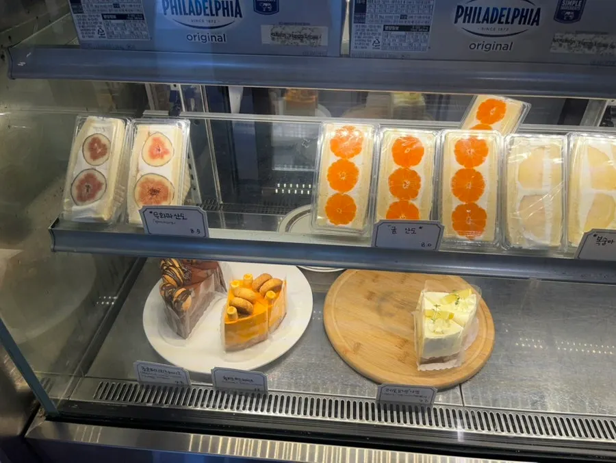 Dessert display case with breads and cakes