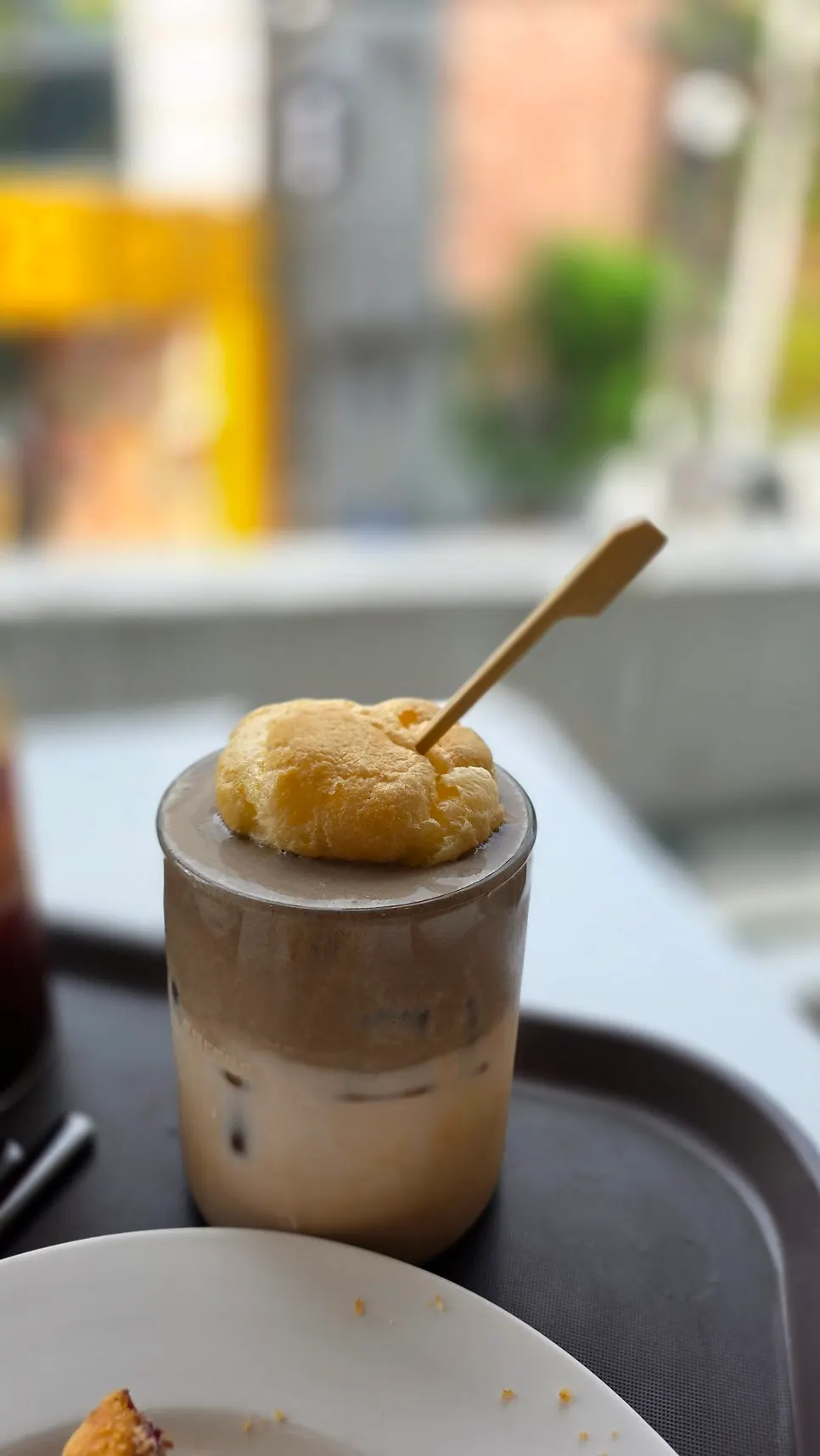 Hojicha choux milk tea with a whole choux pastry on top