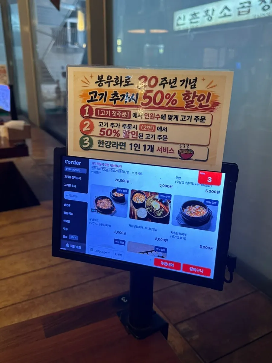 Menu board noting the 20th anniversary 50% off additional order promotion
