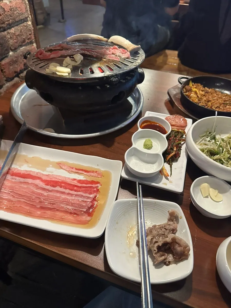 Woo-samgyeop sizzling over the charcoal fire