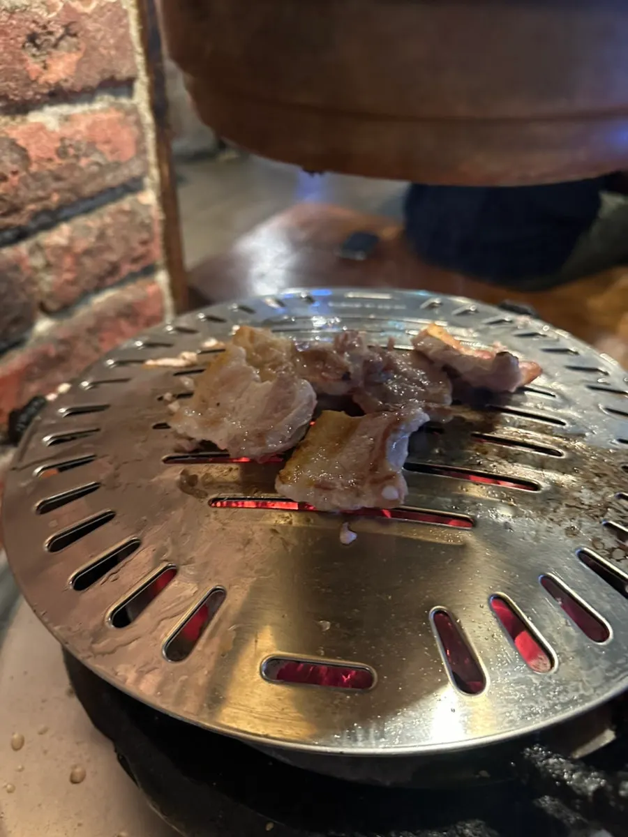 Domestic pork belly grilling on the brazier