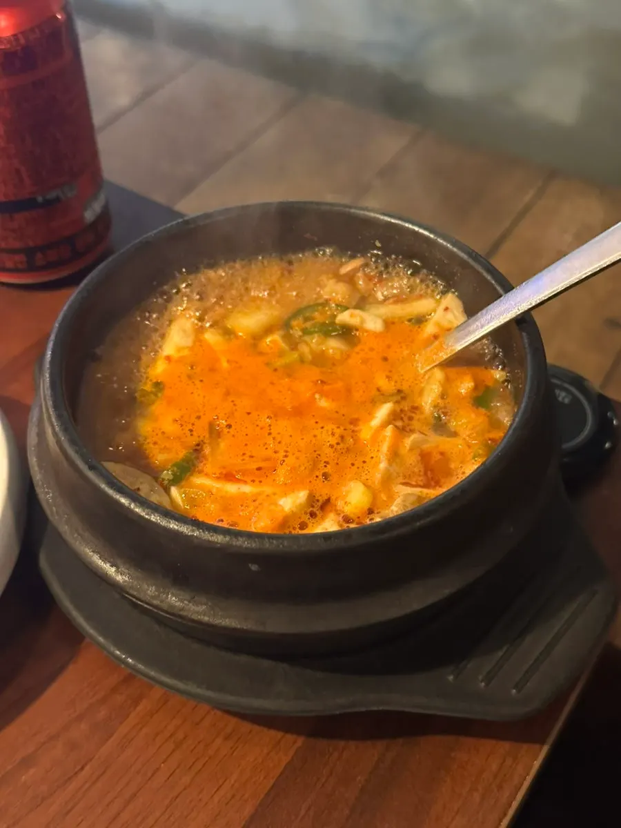 Dwaeji doenjang stew filled with woo-samgyeop, mushrooms, and tofu