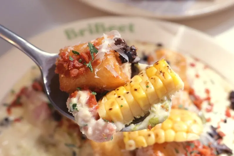 A cream-filled plate of corn and gnocchi