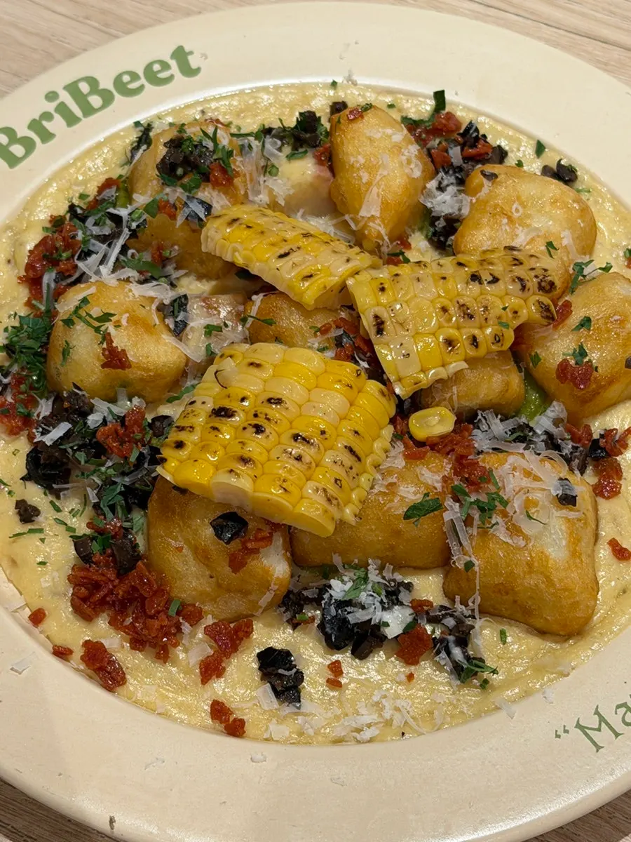 Cream gnocchi topped with corn