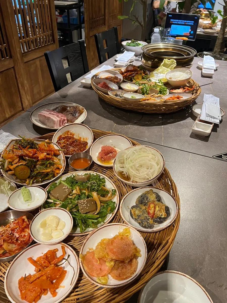 Basic banchan spread with kimchi, acorn jelly salad, pollack roe, and salted oysters