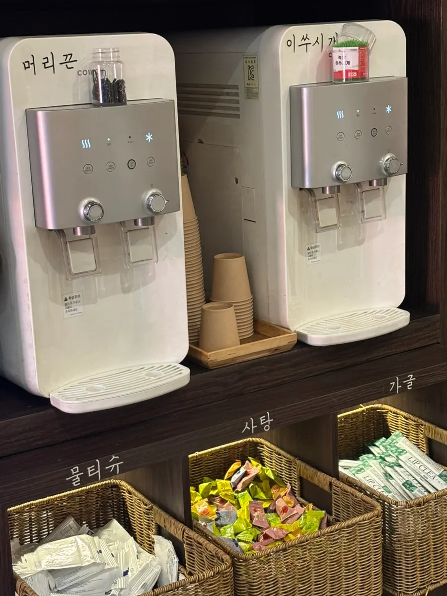 Self-service stand with hair ties, wet wipes, and mouthwash