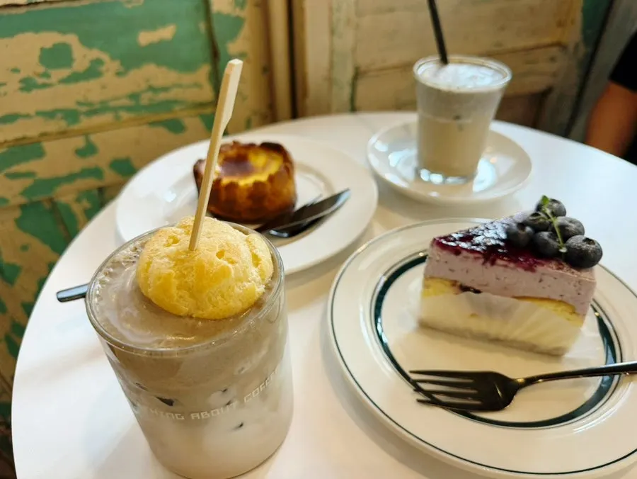 Hojicha milk tea topped with a choux pastry