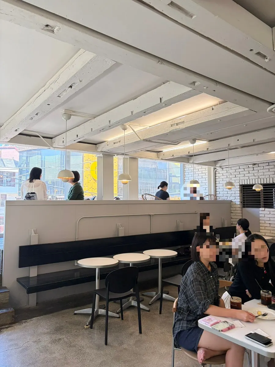 1st floor seating by floor-to-ceiling windows at Upper and Under