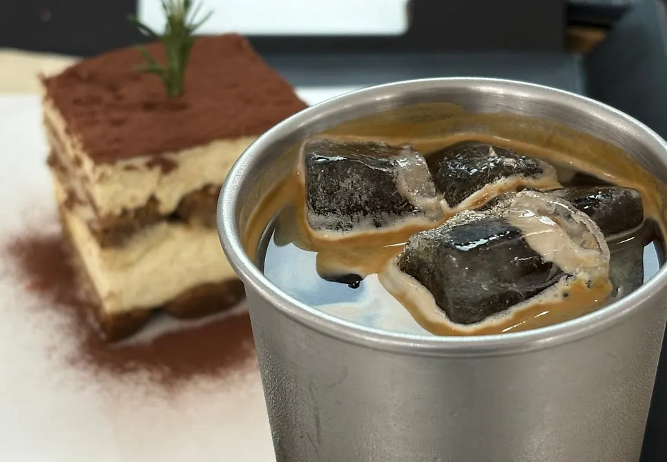 A cup of americano with tiramisu