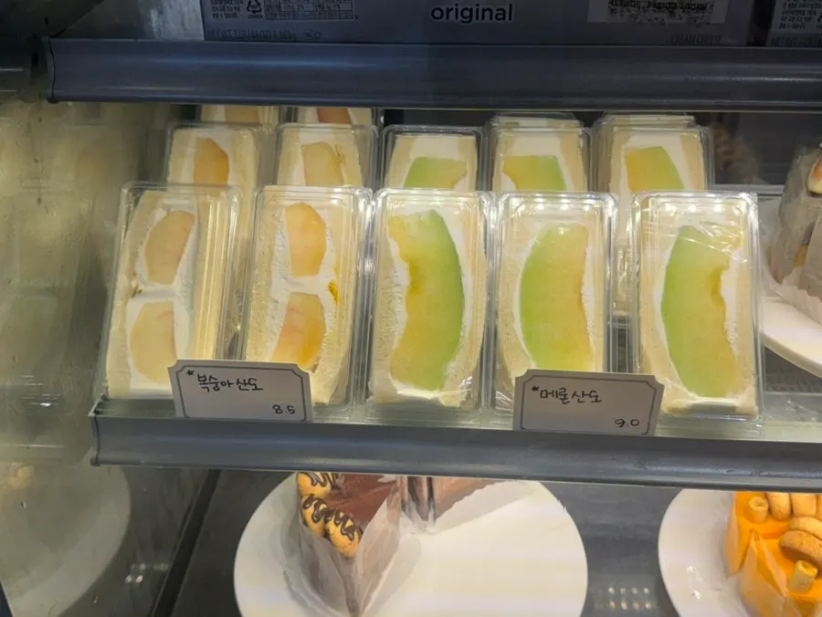 Display case of fruit sando with peach and melon