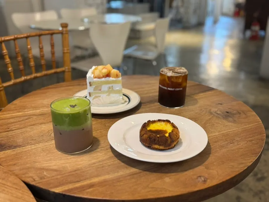 Matcha choco latte, americano, and desserts set on the table