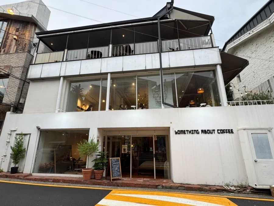 Entrance and hours sign at Something About Coffee