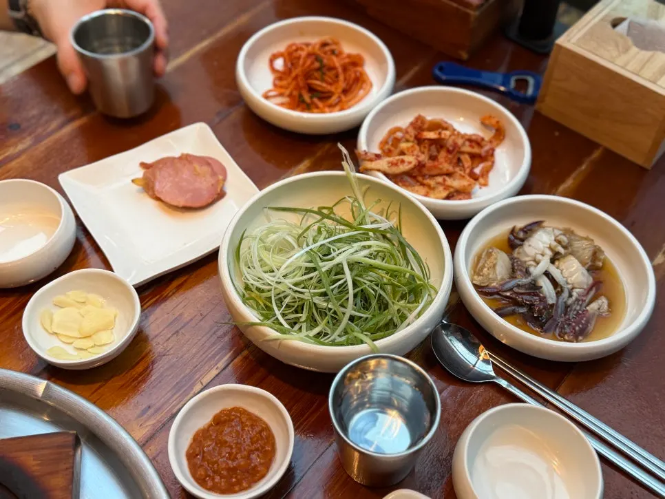 Side dishes at Bongu Hwarro including pickled green onions
