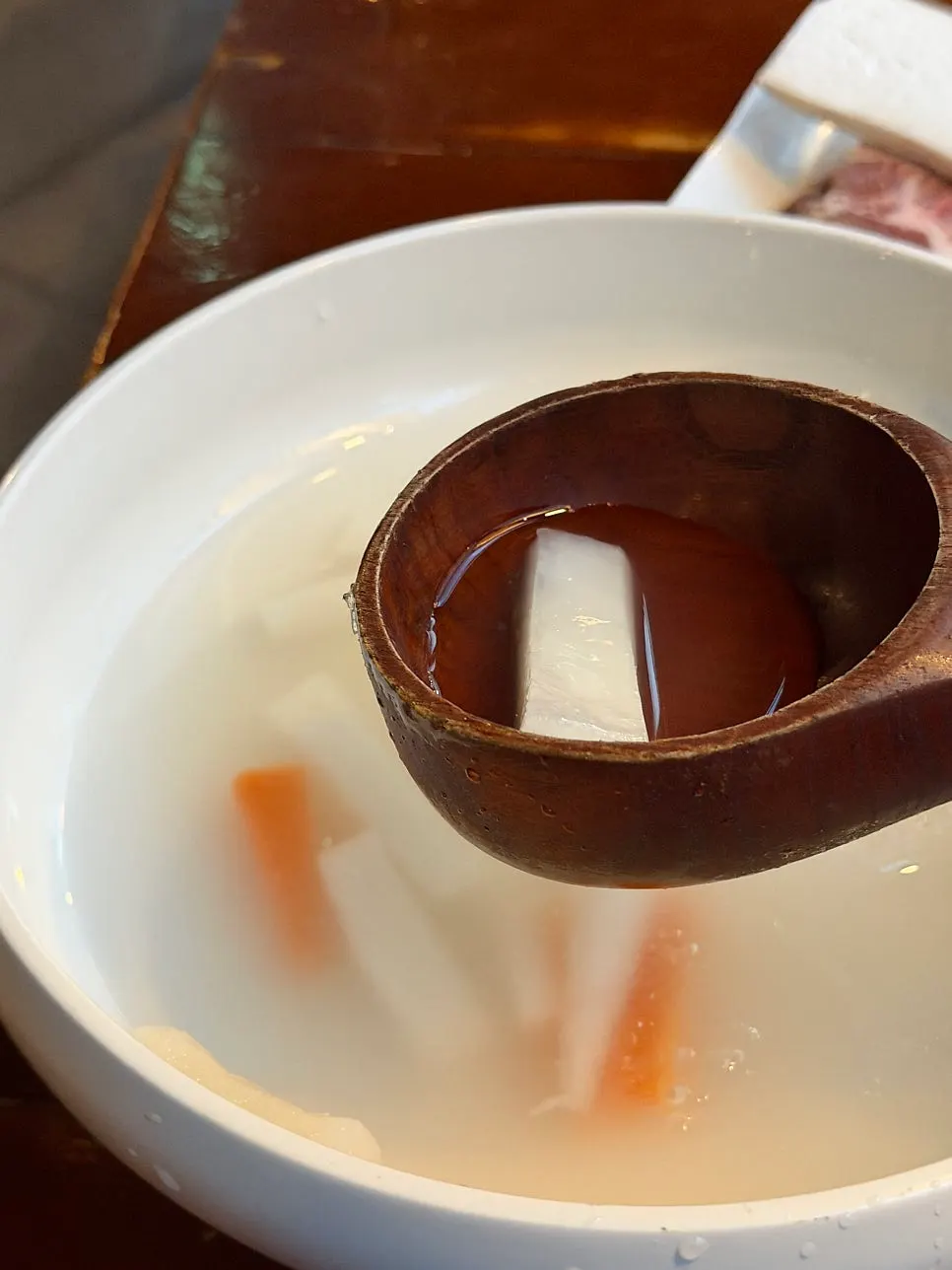 Lifting up a bite of springy naengmyeon noodles