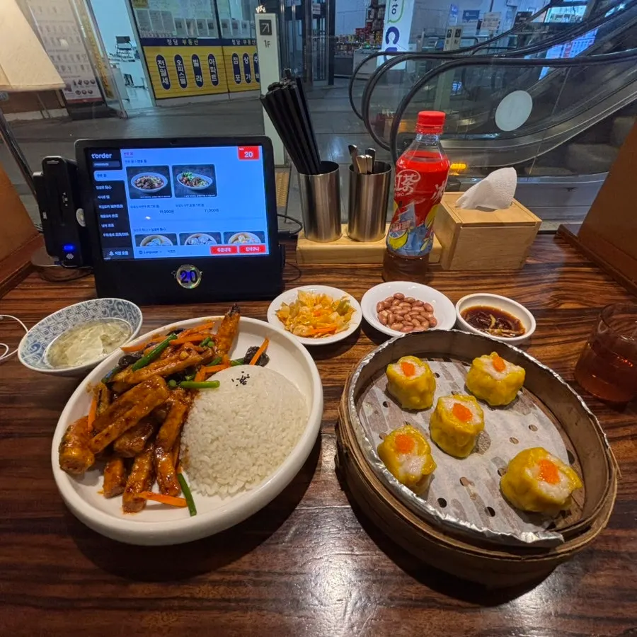 Food laid out on a solo-seat table at Sinbok Myeongwan
