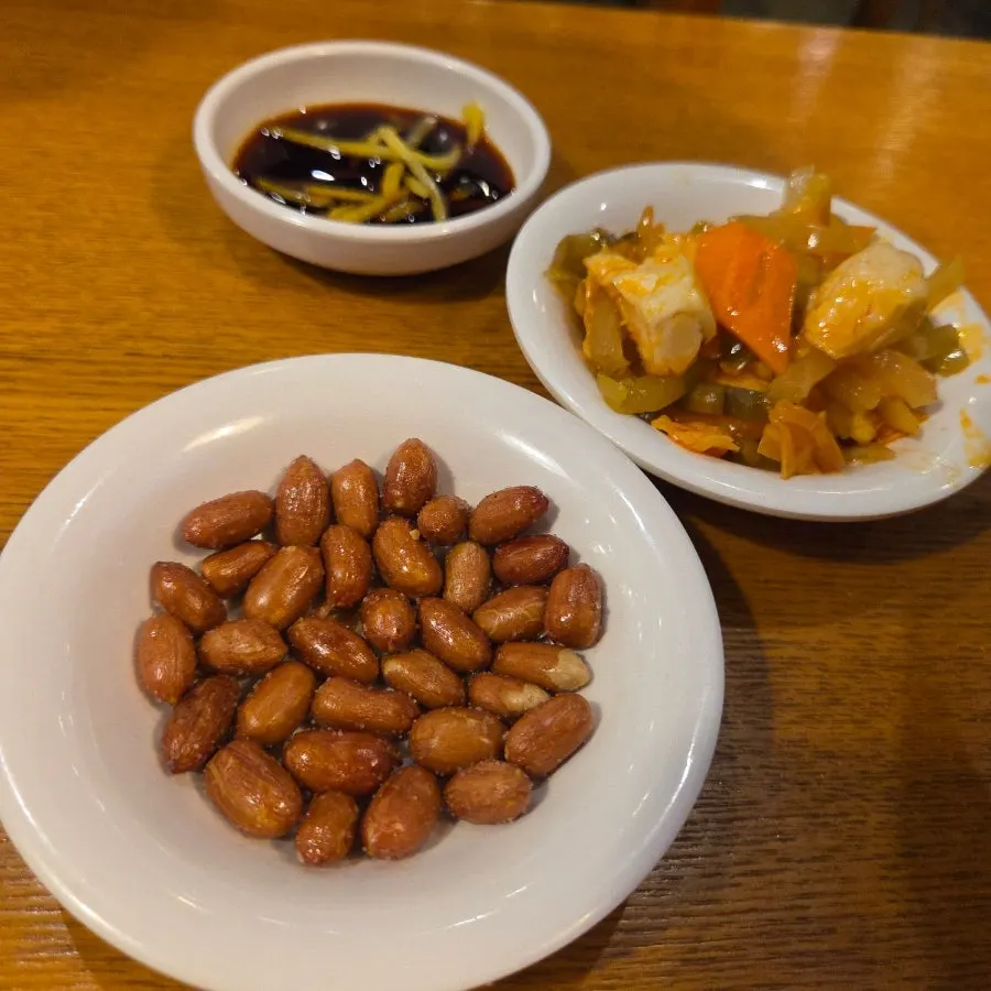 Basic side dishes at Sinbok Myeongwan, including peanuts