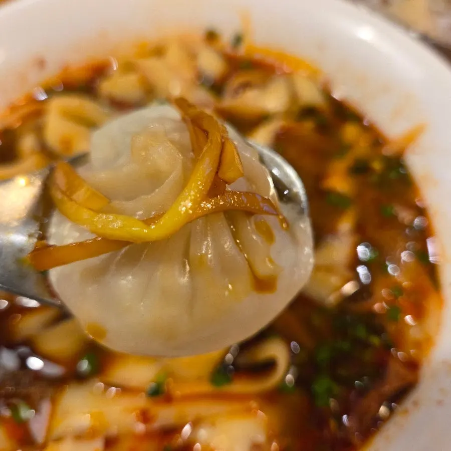 Closing shot of beef dosakmyeon and dim sum at Sinbok Myeongwan