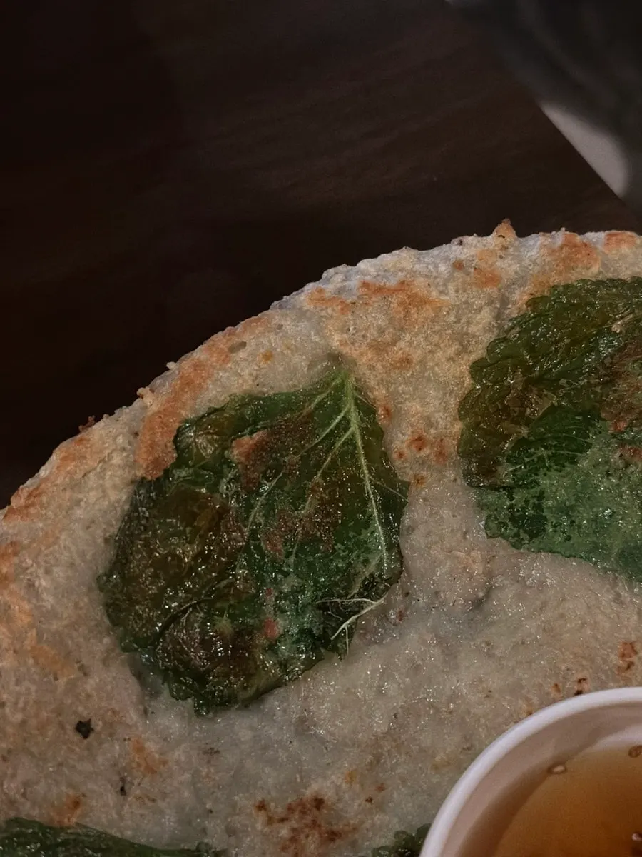 Cross-section of the potato pancake showing large perilla leaf pieces