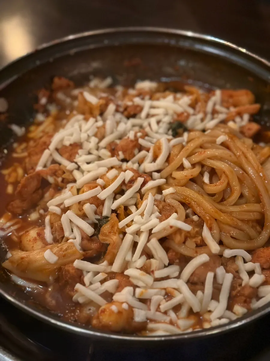 Cheese dakgalbi cooking on the griddle
