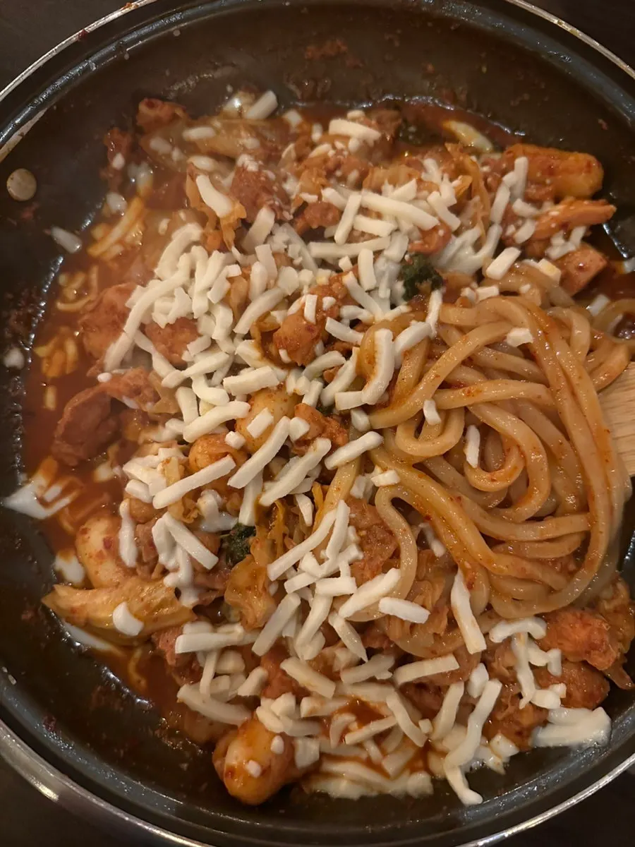 Dakgalbi in red sauce topped with a generous layer of cheese