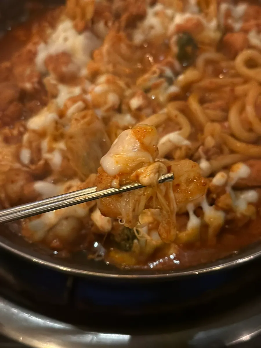 Dakgalbi on the griddle with the cheese fully melted
