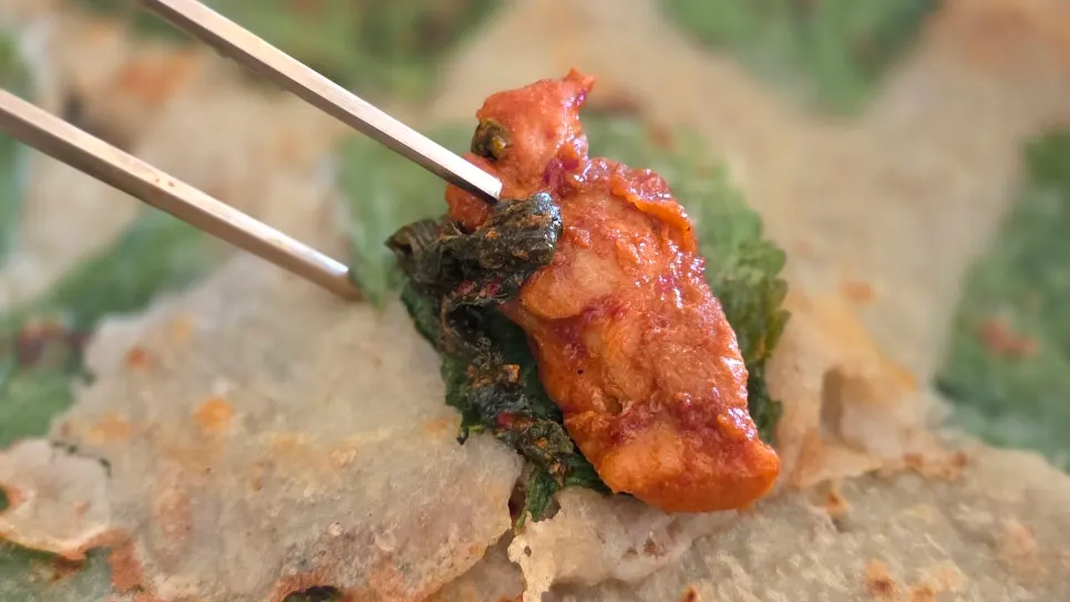 Wrapping dakgalbi in potato pancake