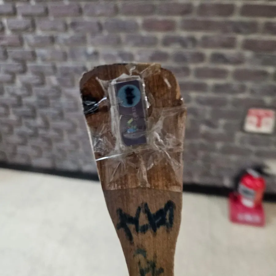 Bathroom key attached to a rice paddle